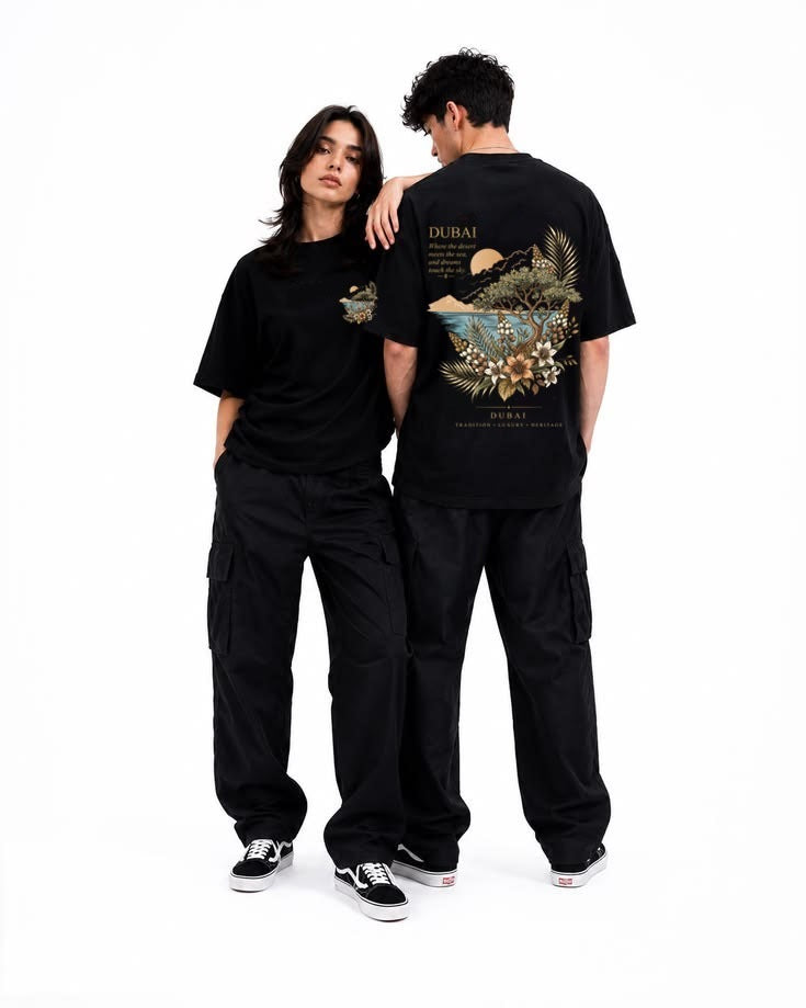 Couple wearing black Dubai Oasis oversized tees, front chest logo and oasis back print