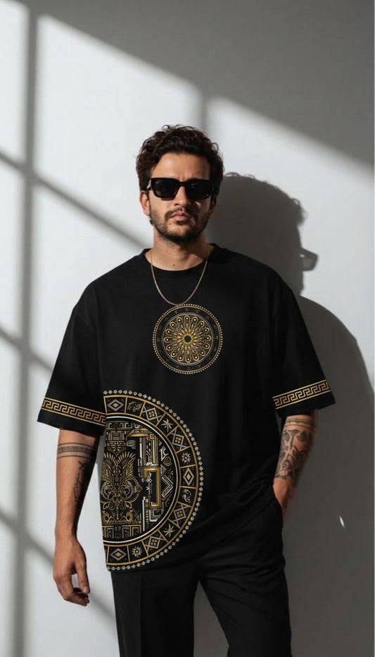Man wearing the black Mandala Heritage oversized tee with gold mandala prints and sleeve bands
