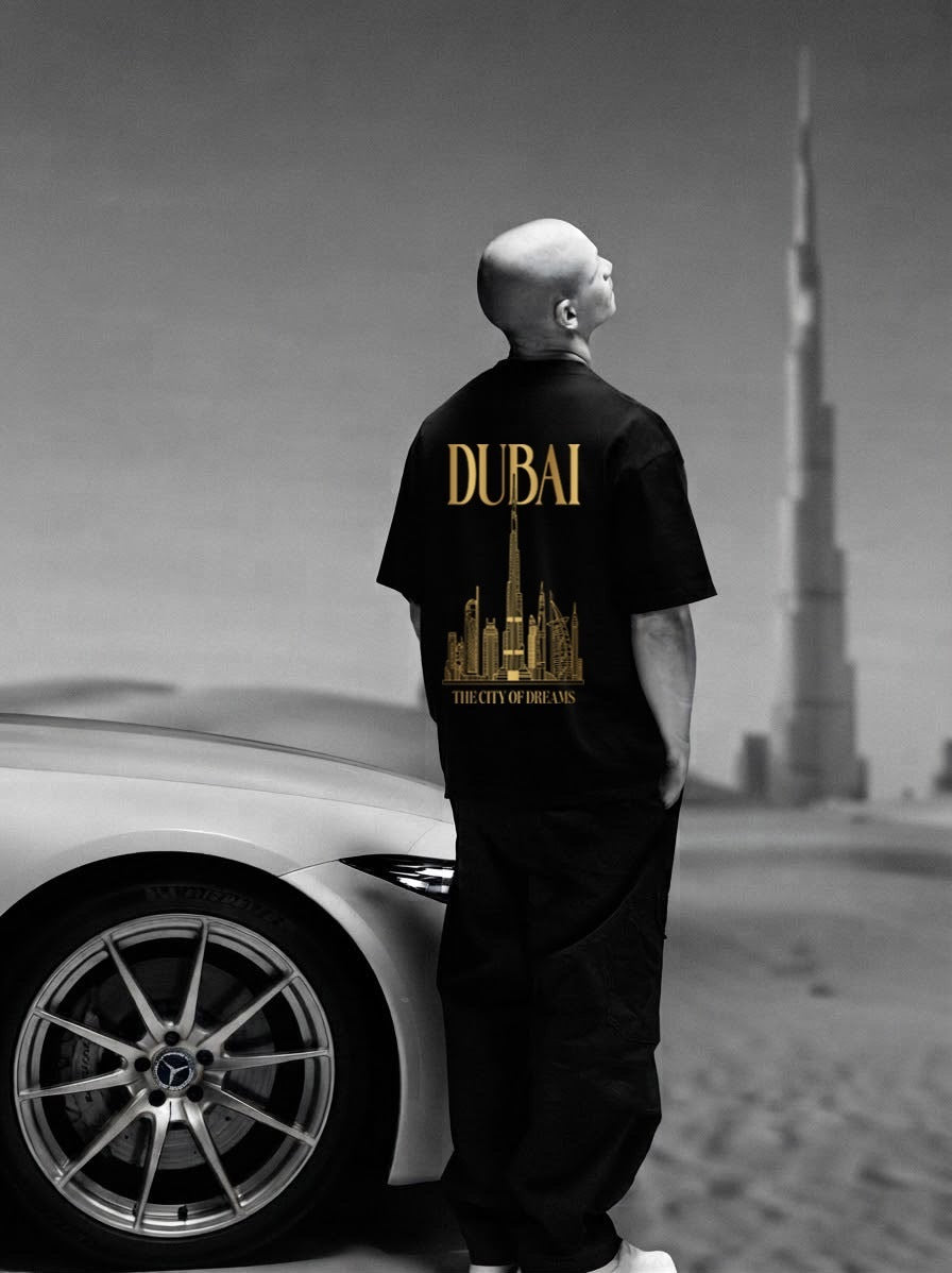 Back of the black City of Dreams oversized tee with the gold DUBAI The City of Dreams skyline print