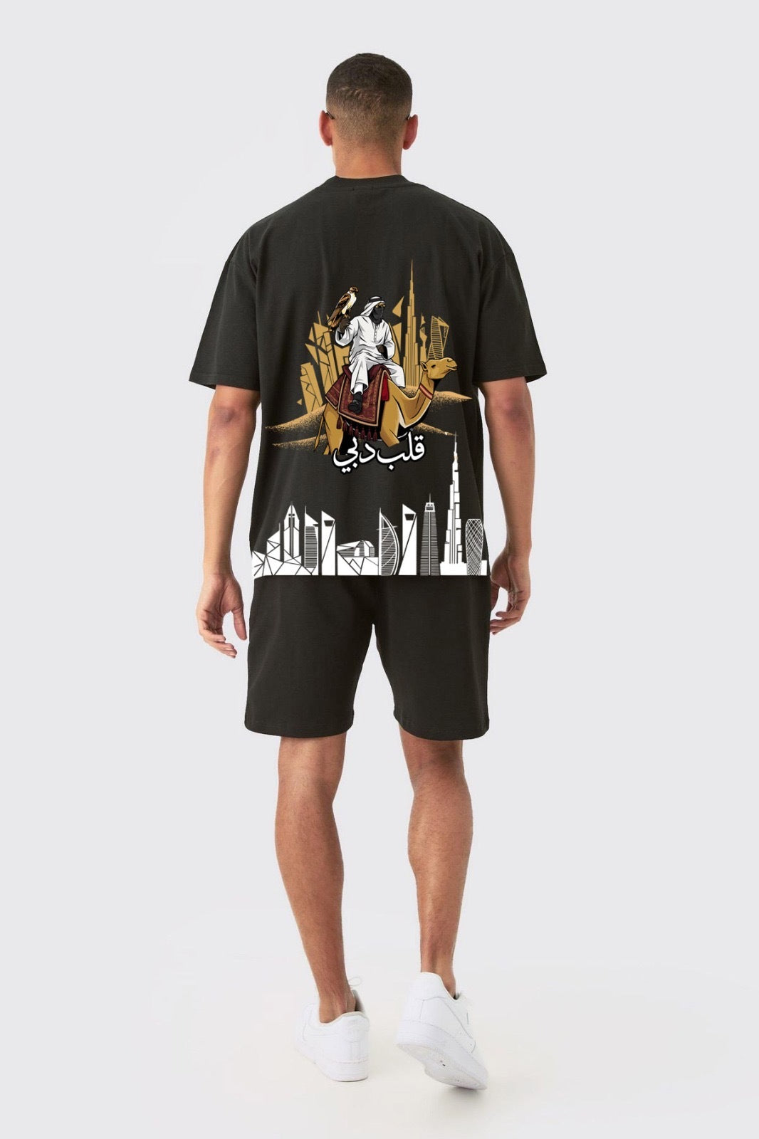 Back of the black Dubai's Heart oversized tee with a falconer on a camel and the Dubai skyline