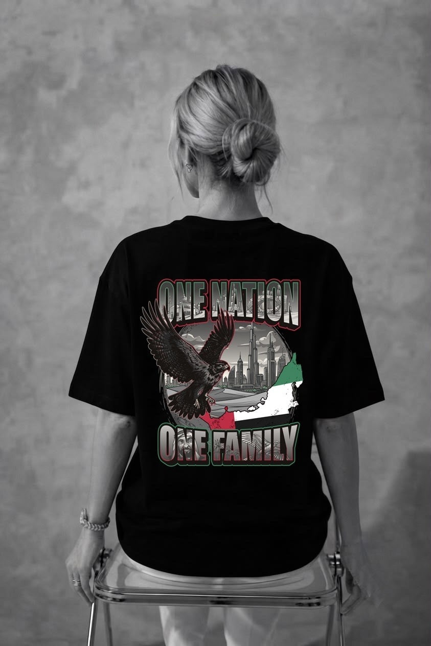 Woman wearing the black One Nation One Family oversized tee, back print view