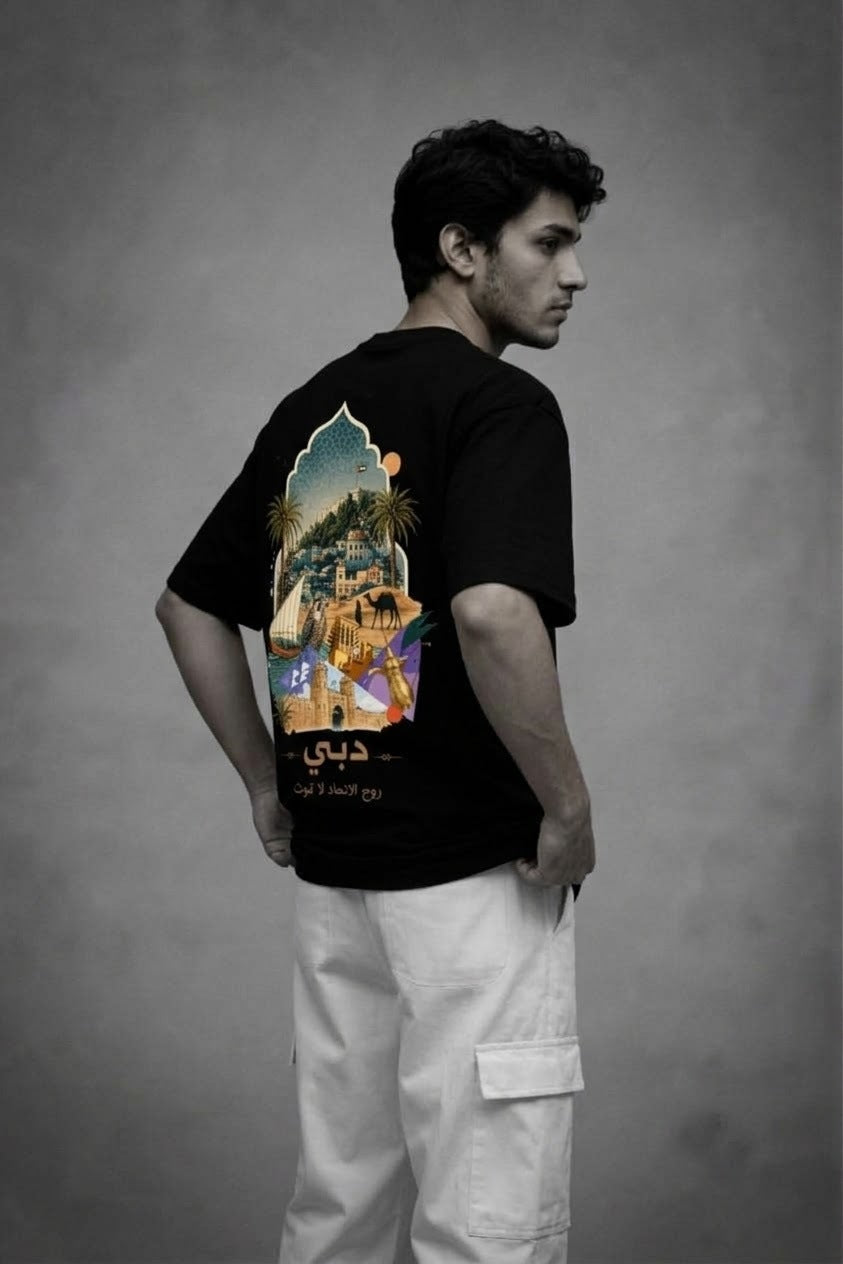 Side back view of the black City of Gold Heritage oversized tee with the Dubai print