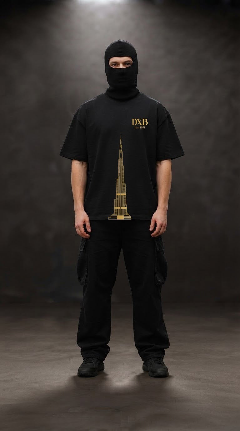 Model in the black City of Dreams oversized tee with the gold Burj Khalifa front print