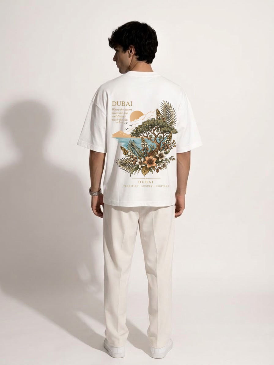 Man wearing the white Dubai Oasis oversized tee with the Where the desert meets the sea back print