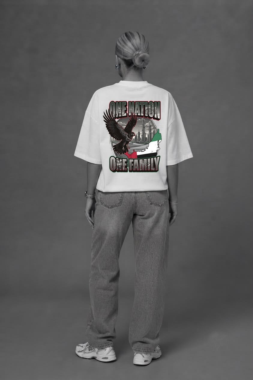 Woman wearing the white One Nation One Family oversized tee, back print view