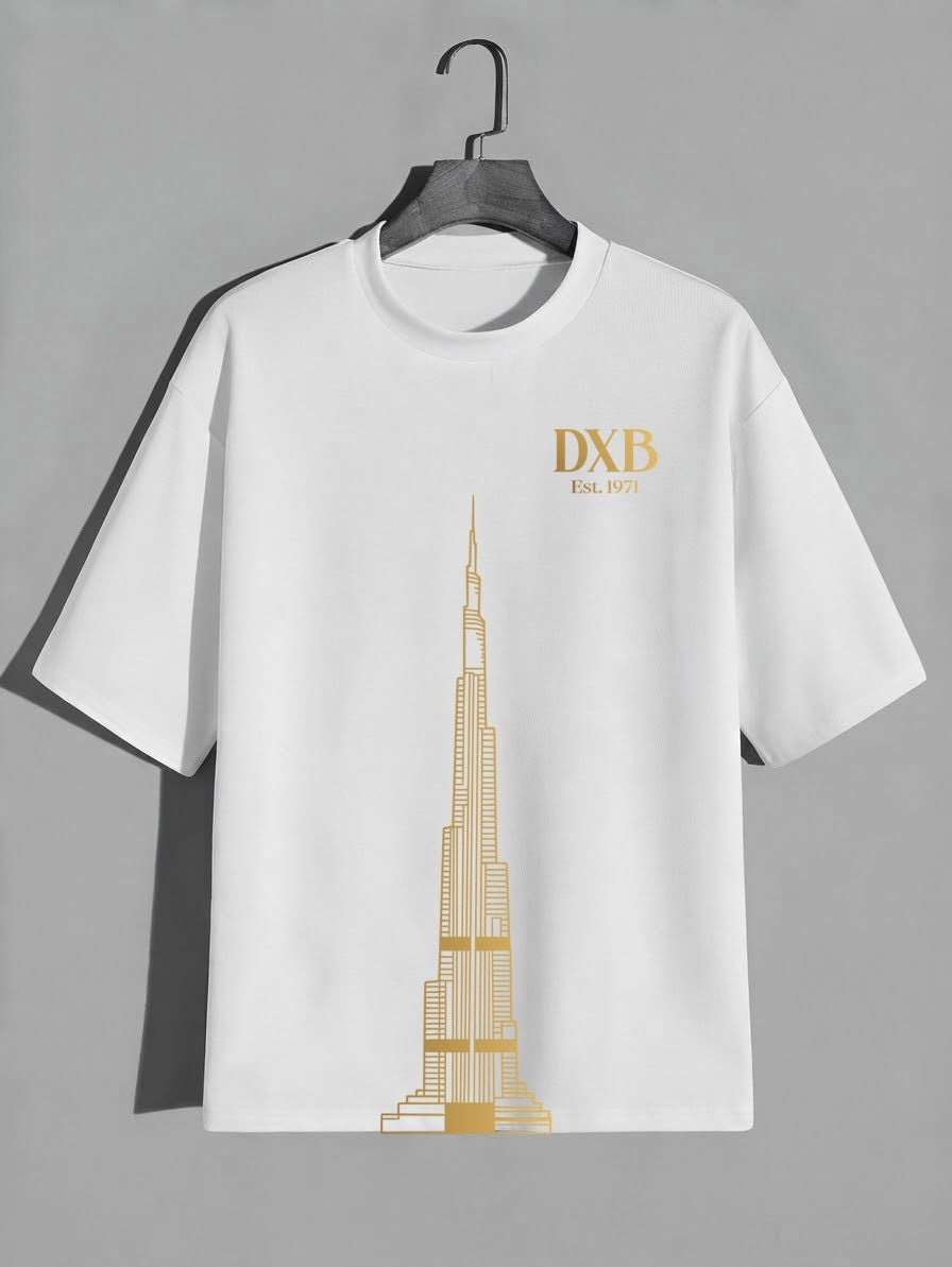 White City of Dreams oversized tee with the gold DXB Est. 1971 Burj Khalifa print on a hanger